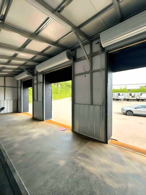 Interior of a YRG modular cross-docking platform in Massachusetts, with dock doors open to a staging yard with parked trailers.